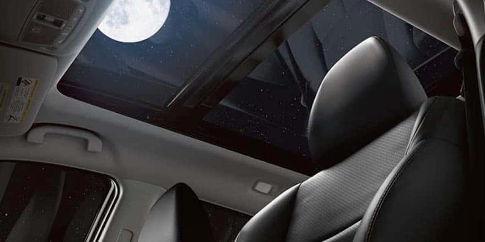 The moon is shown through the moon roof in a 2020 Nissan Rogue.