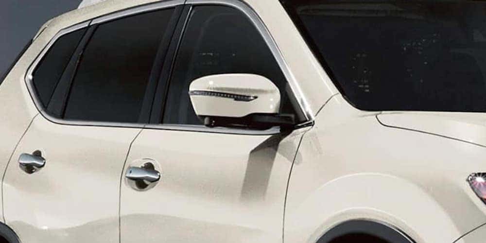 The passenger side of a white 2020 Nissan Rogue is shown.
