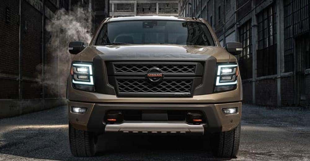 A brown 2020 Nissan Titan is shown from the front in an alley.