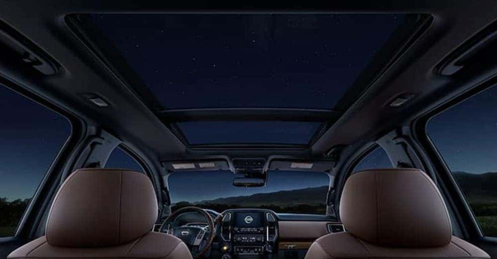 A night sky is shown in the moon roof in a 2020 Nissan Titan.