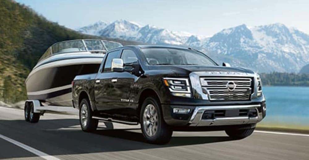 A black 2020 Nissan Titan is towing a boat.