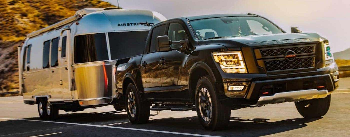 A black 2021 Nissan Titan is towing an Airstream trailer.