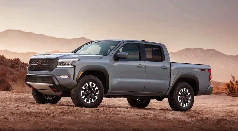 A gray 2022 Nissan Frontier Pro4x is shown parked on the dirt.