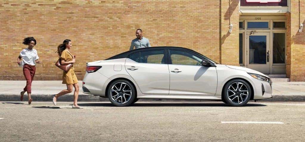 2024-nissan-sentra-parked-profile-as-people-approach