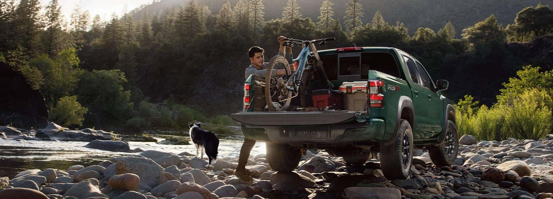 Tactical Green 2022 Nissan Frontier on a rocky river