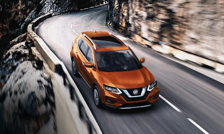 2020 Nissan Rogue driving on a rocky highway