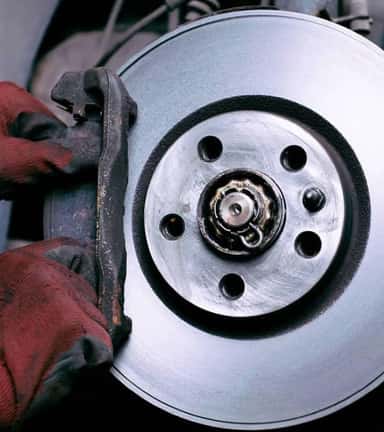 Service tech working on brakes