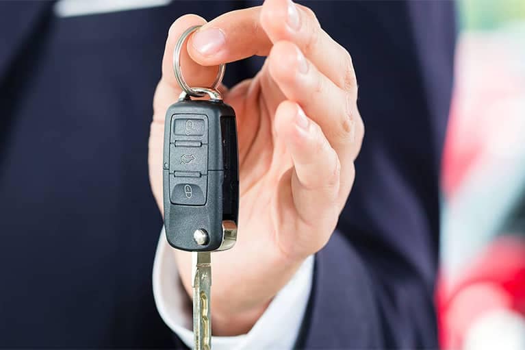 Person in Suit Holding Car Keys