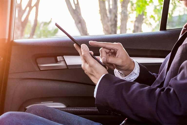Man in Suit Using Smartphone