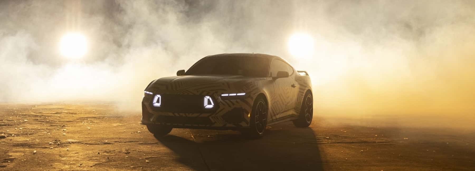2025-Ford-Mustang-surrounded-by-smoke-and-lights-behind-it