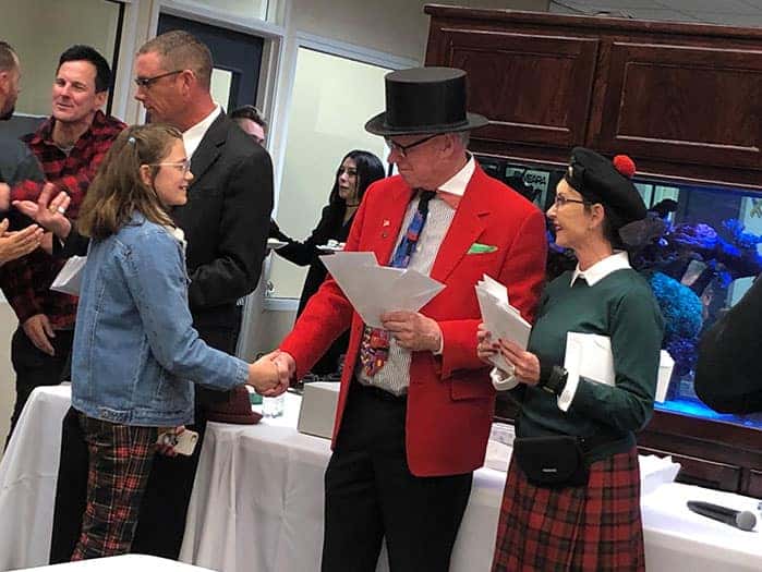 Man in top hat shaking hands