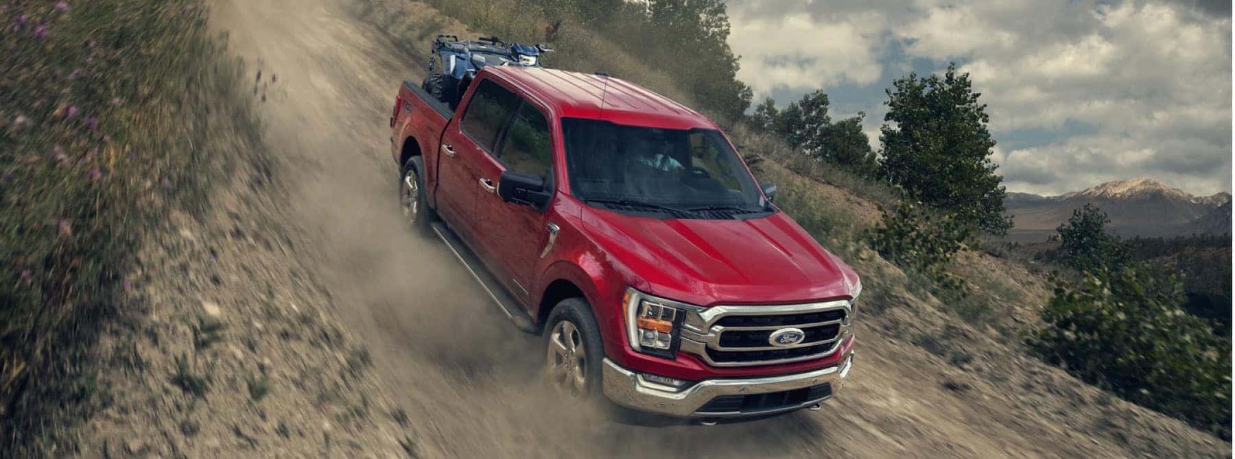 Truck driving down dirt road