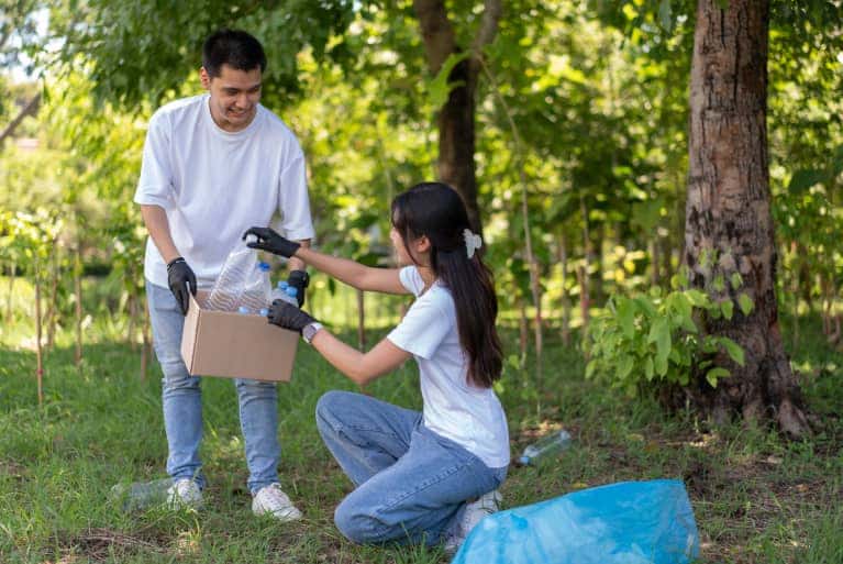 young people cleaning up trash