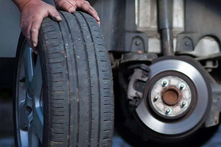 Mechanic changing a wheel of a modern car
