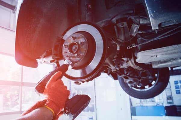 A mechanic working on brakes.