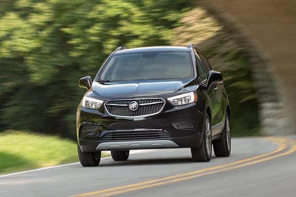 A black 2022 Buick Encore driving on a highway.