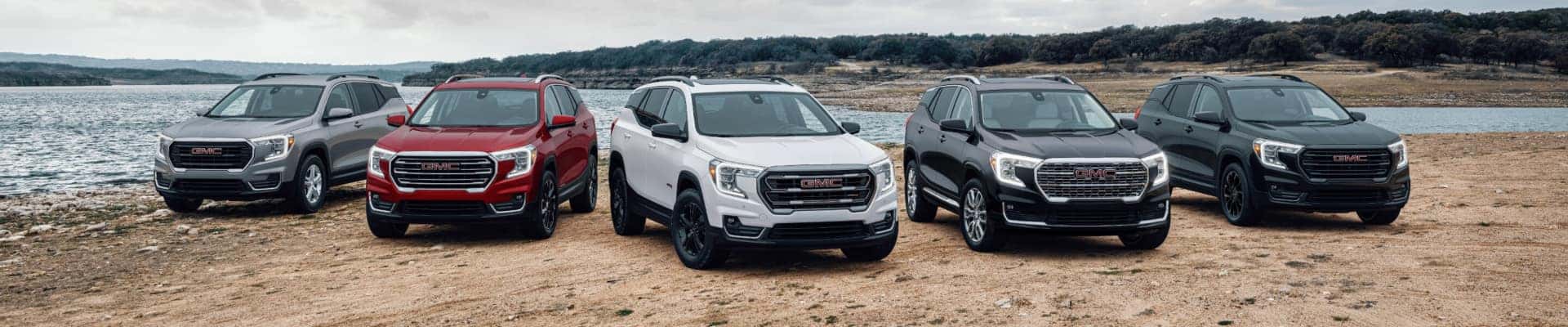 Several 2024 GMC Terrains parked near water.