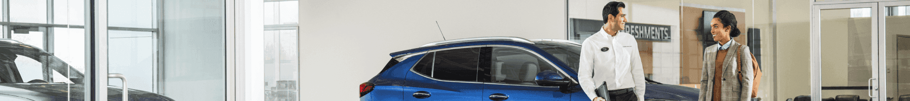 Two people talking in a dealership.