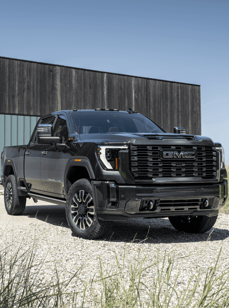 A black 2023 GMC Sierra HD parked on a driveway.