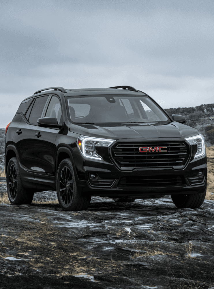 A black 2023 GMC Terrain parked off-road.