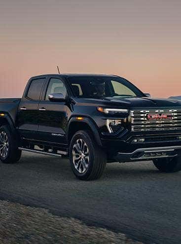 A black 2023 GMC Canyon parked.