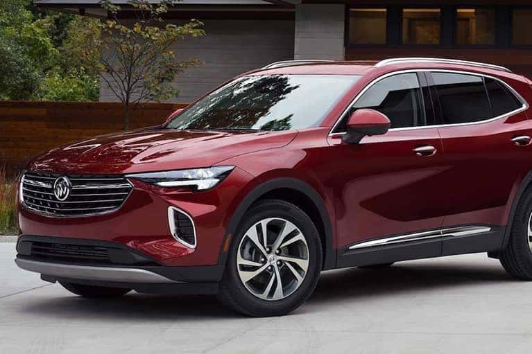 A red 2023 Buick Envision parked on a sunny day.