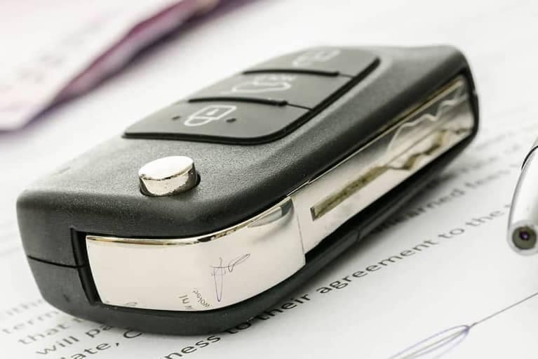 Car Key and Pen on Documents