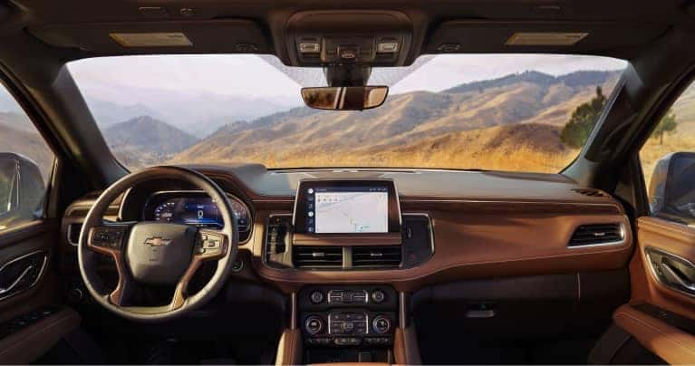 An interior view of a chevy vehicle looking out the front toward the dashboard