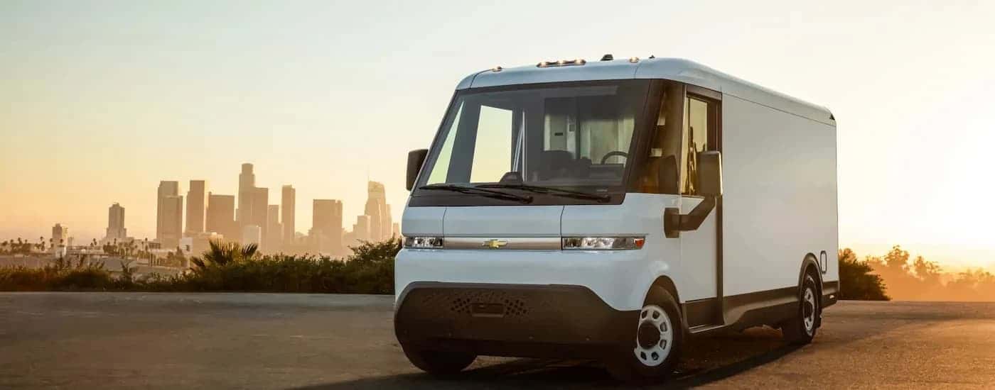 A white 2025 Chevy BrightDrop van parked in a lot and angled left.
