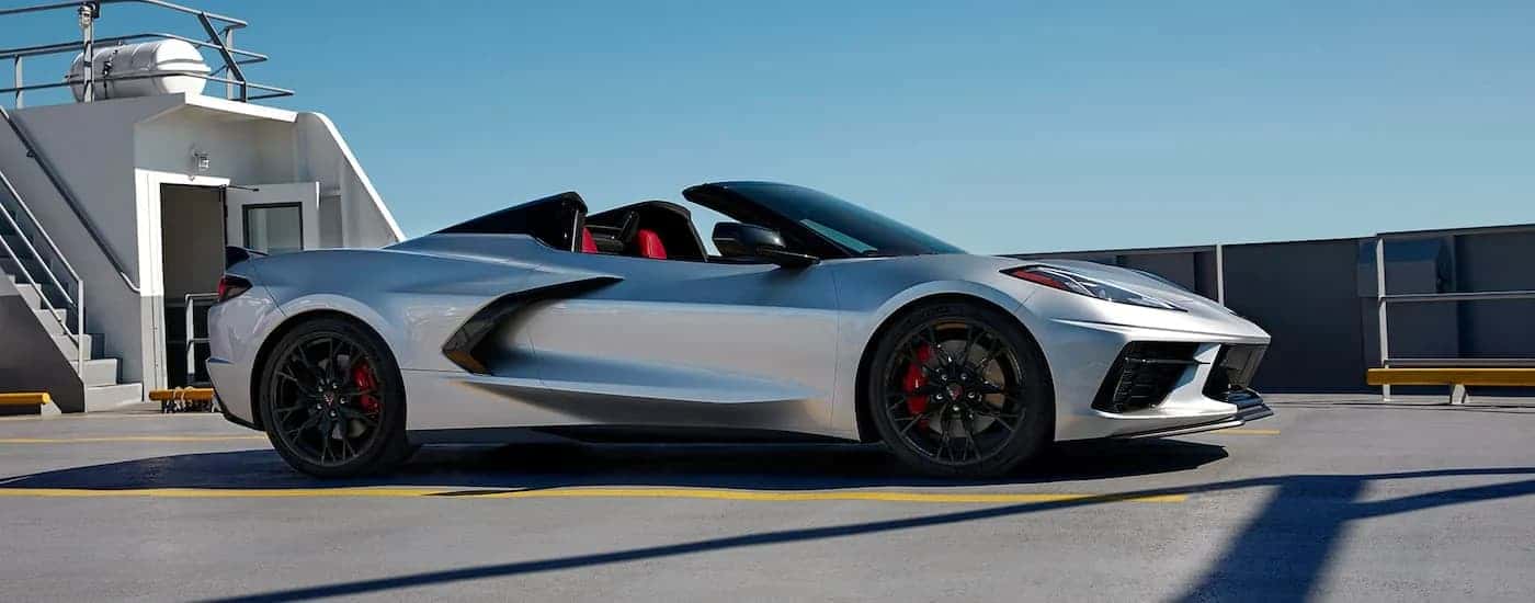 Side angle view of a silver 2023 Chevy Corvette Stingray 3LT parked on a boat.