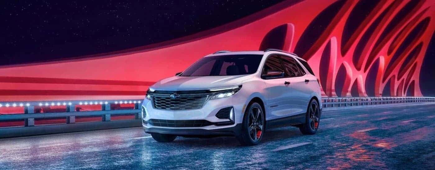 White 2024 Chevy Equinox Redline driving over a bridge.