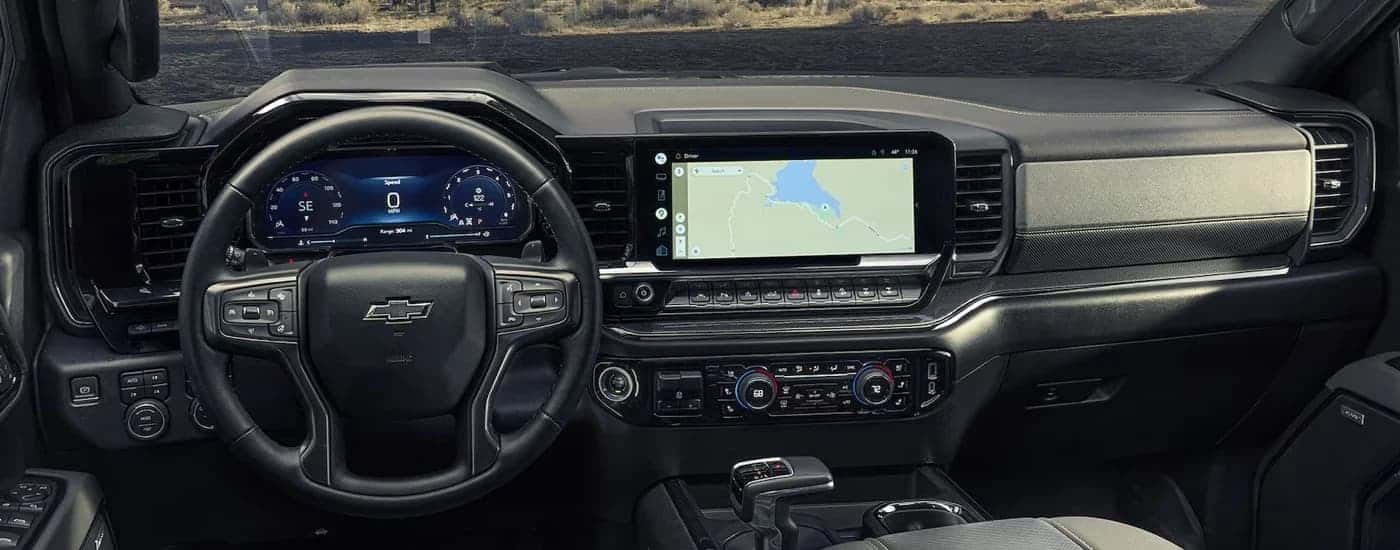The steering wheel and infotainment screen in a 2024 Chevy Silverado 1500 for sale.