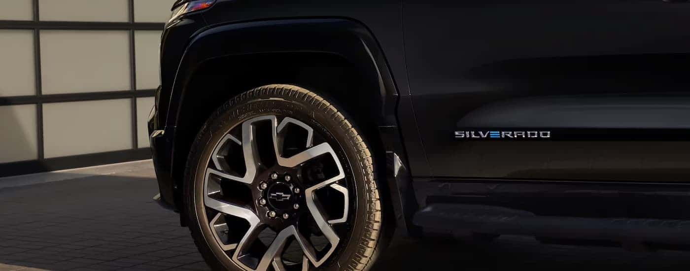 The rim of a black 2025 Chevy Silverado EV at a Houston electric Silverado dealer.
