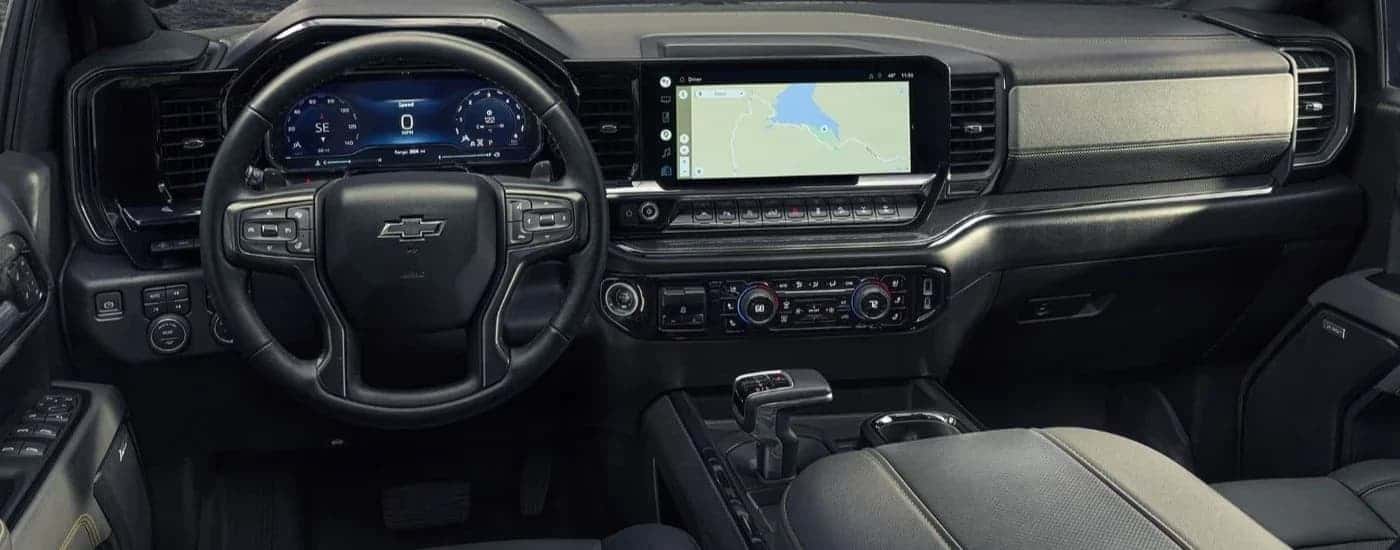Black wheel and dashboard inside of a 2022 Chevy Silverado 1500.