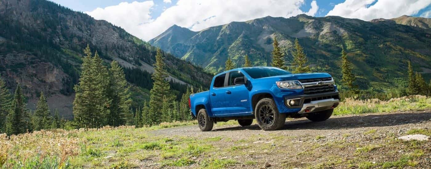 A blue 2022 Chevy Colorado Z71 parked off-road in the mountains.
