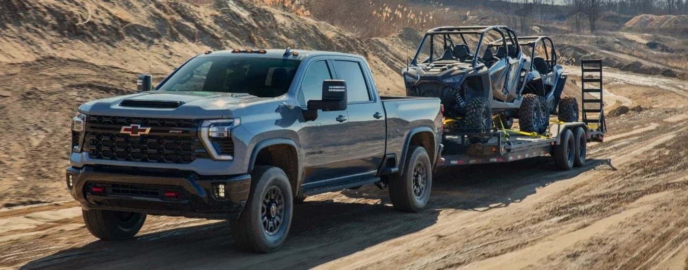 A grey 2024 Chevy Silverado 2500 HD ZR2 driving to look at used trucks for Sale near Prairie View.