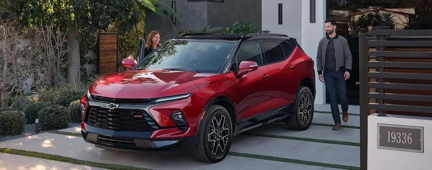 A red 2024 Chevy Blazer parked on a driveway.
