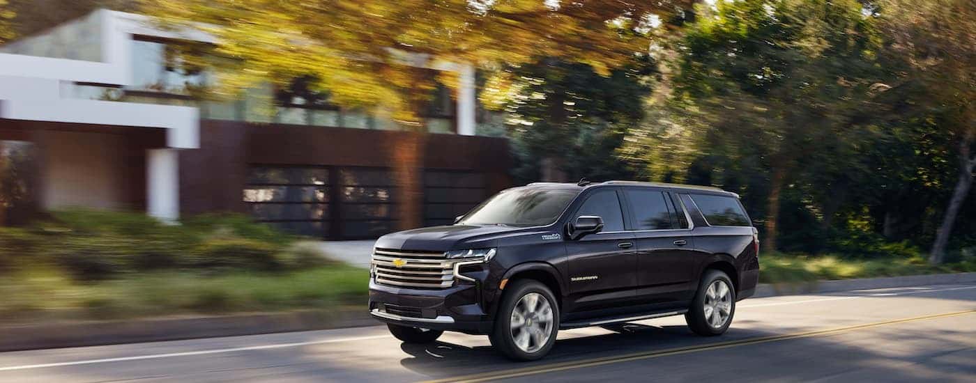 A grey 2022 Chevy Suburban is shown from the front at an angle after leaving a used Chevy dealer near Porter