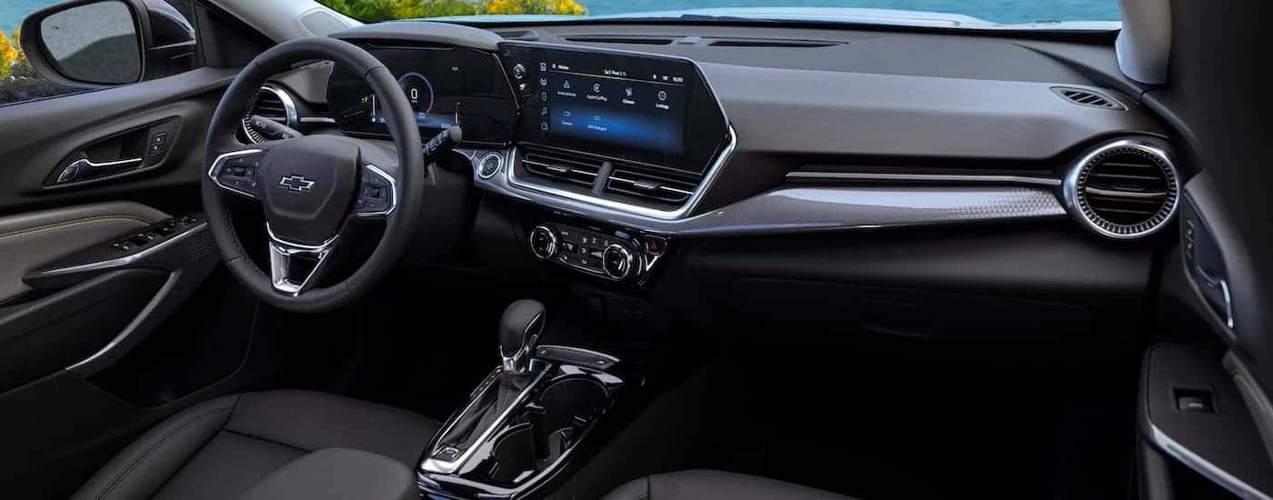 The black interior of a 2024 Chevy Trax Activ is shown from the passenger seat.