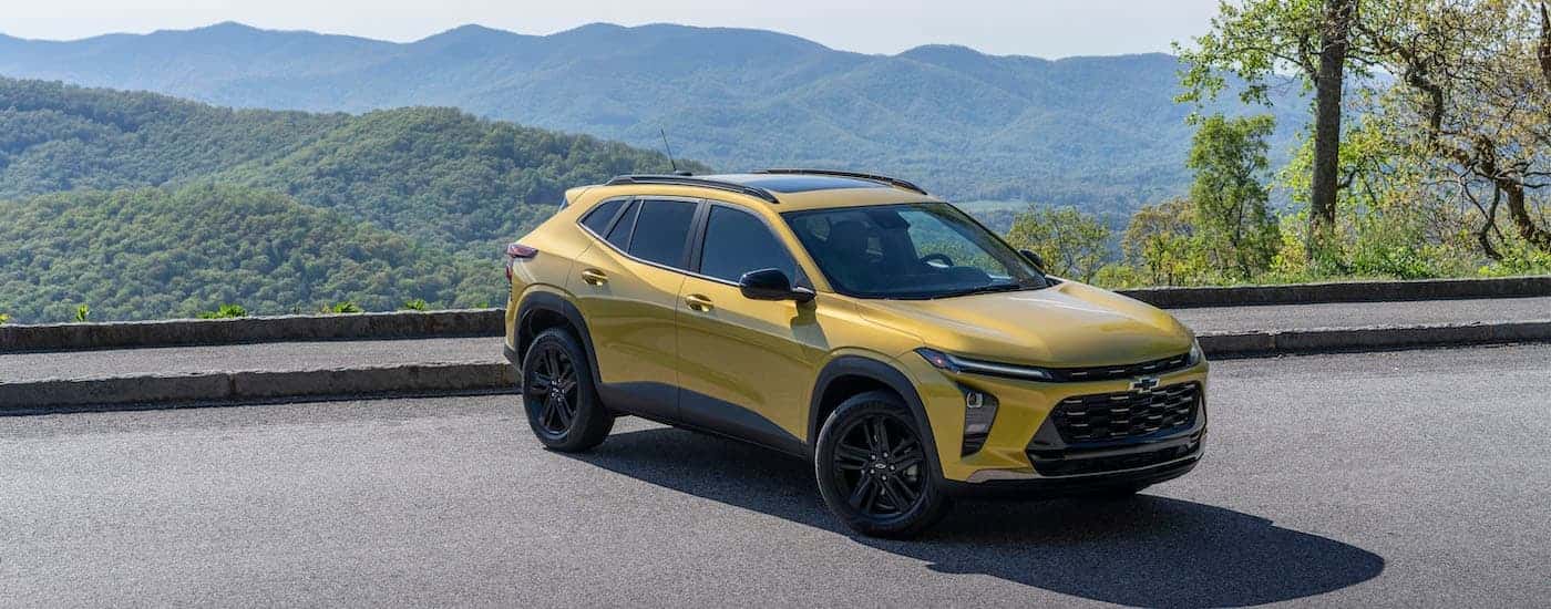 A yellow 2024 Chevy Trax Activ is shown from the front at an angle after leaving a dealer that has a Chevy Trax for sale.