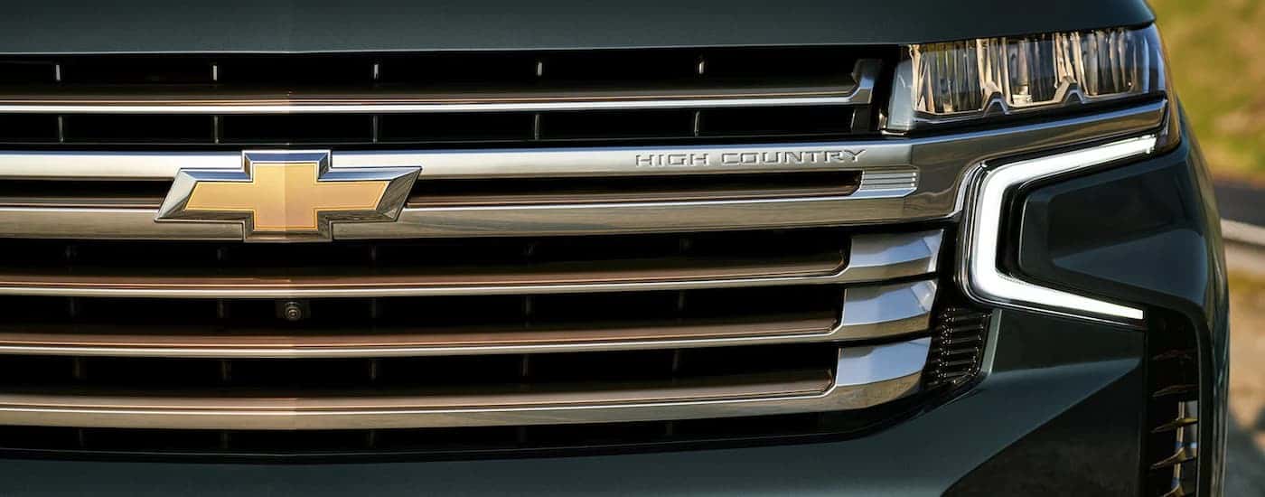 A close up of the grille on a green 2022 Chevy Tahoe High Country is shown