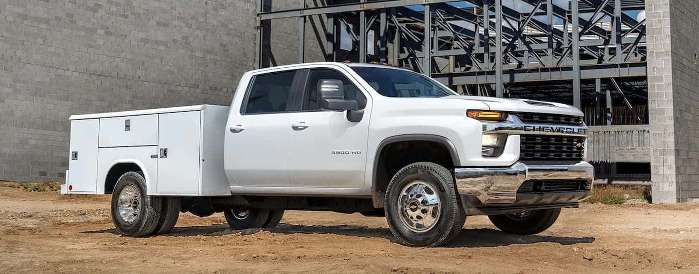 A white 2022 Chevy Silverado 3500HD is shown parked at a construction site