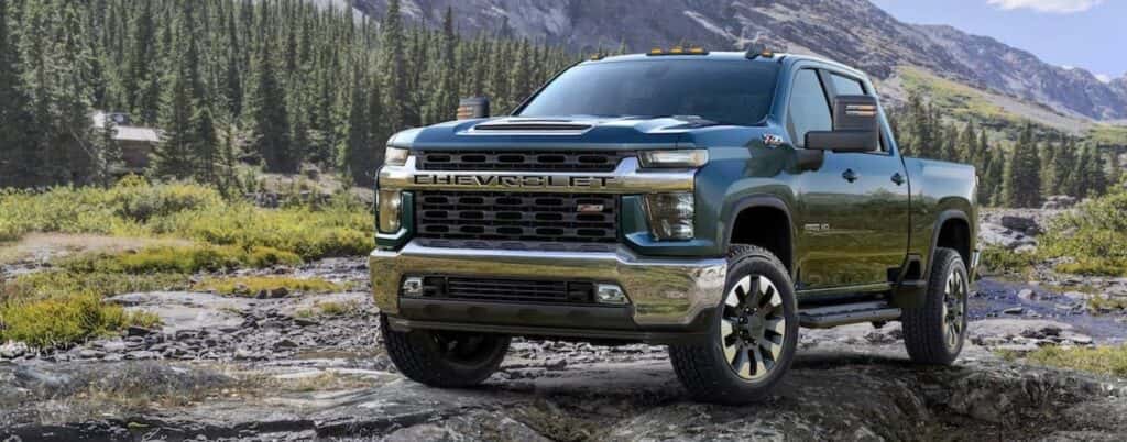 A blue 2020 Chevy Silverado 2500 HD Z71 parked off-road on a cliff.