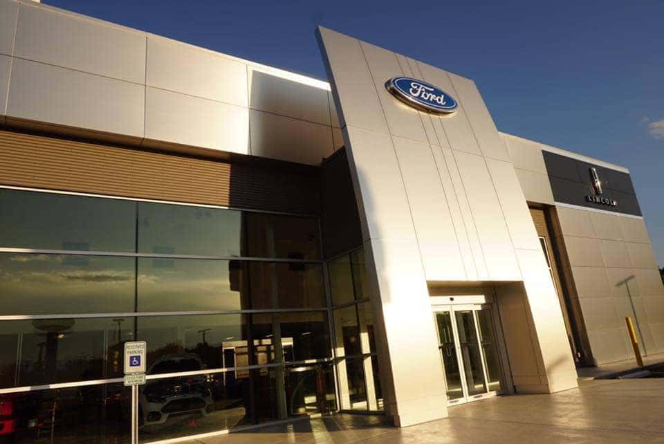 People hanging around a Ford vehicle