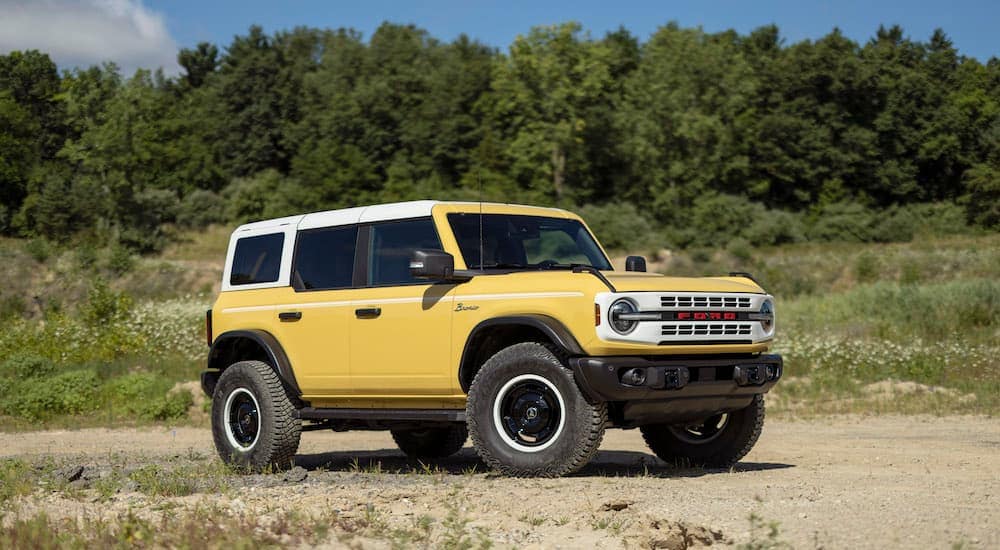 A yellow 2023 Ford Bronco Heritage Edition is shown from the side at an angle.