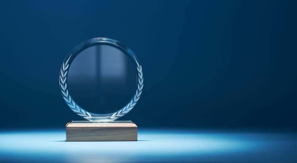 A blue crystal trophy is shown.