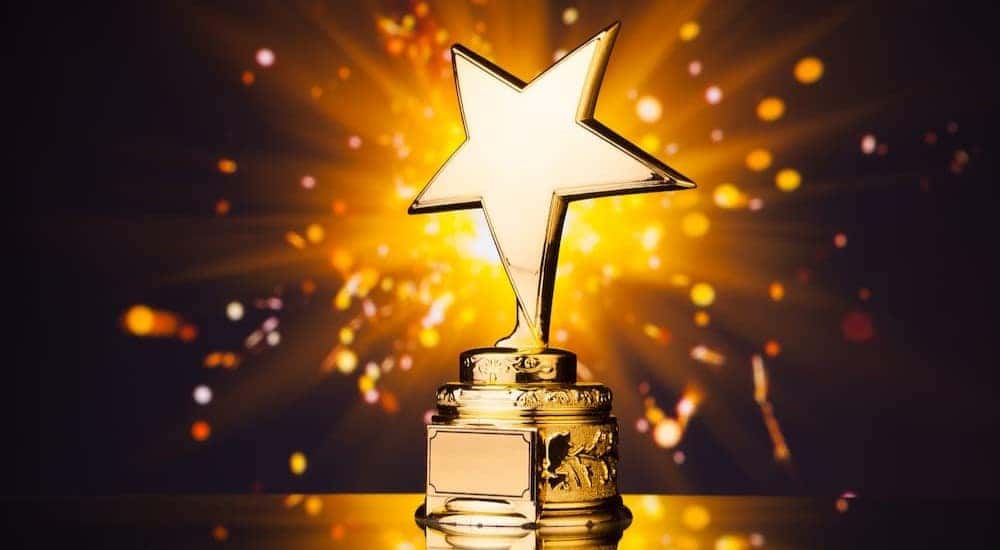 A golden star trophy is shown.