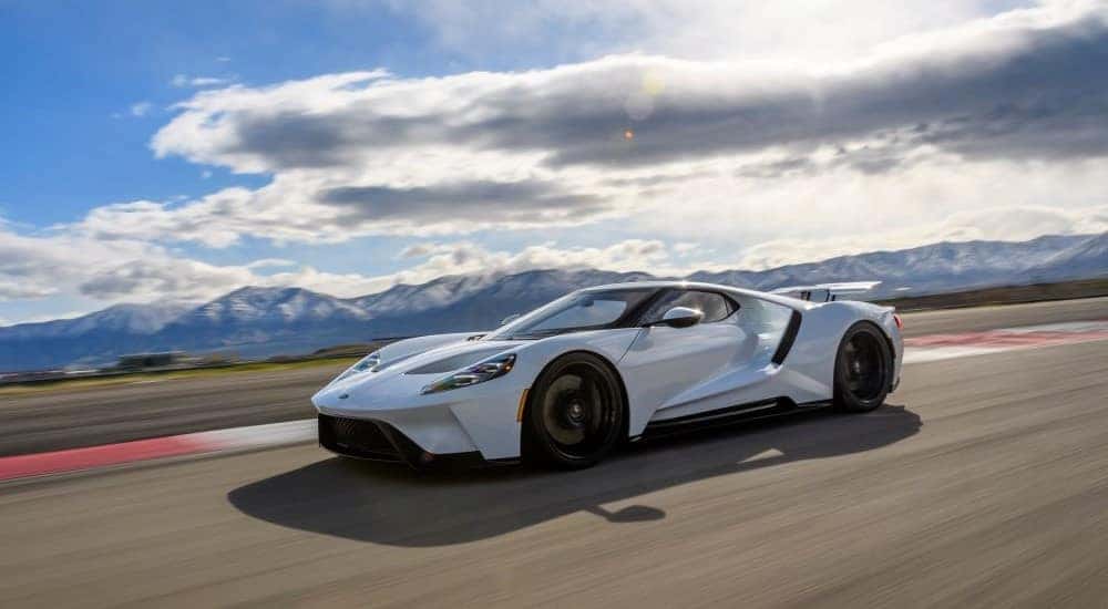 A white 2017 Ford GT is shown on a track on a cloudy day.