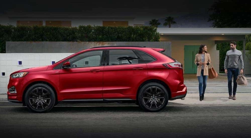 A red 2021 Ford Edge is shown from the side.