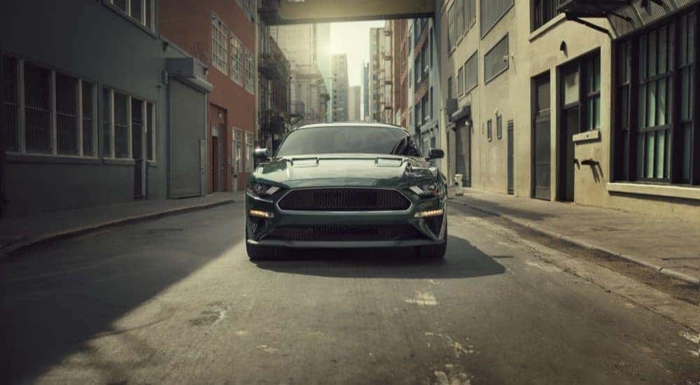 A green 2020 Ford Mustang BULLITT is shown parked in an alleyway.